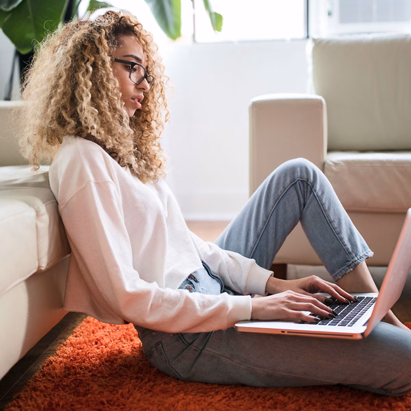 Woman Sitting on Floor Working